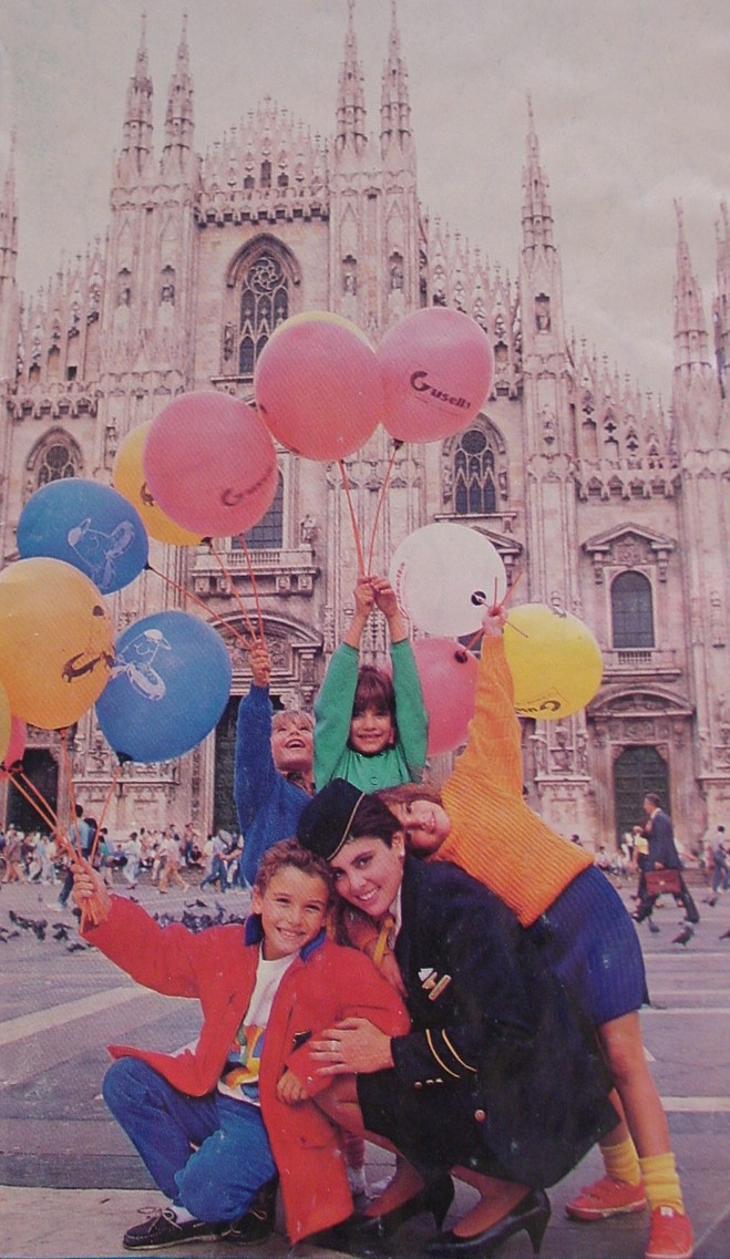 1980s A Pan Am Purser poses with children in Milan.